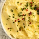 pinterest image with title of a bowl of creamy mashed potatoes with truffles.