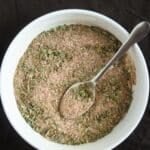 pinterest image with title of a small bowl with beef spices with a spoon in it.