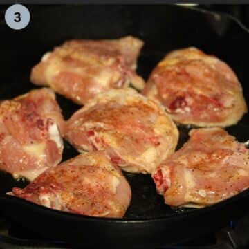 six still raw chicken thighs skin side down in the cast iron skillet.