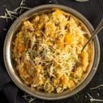 Chicken and pumpkin risotto on a silver plate.