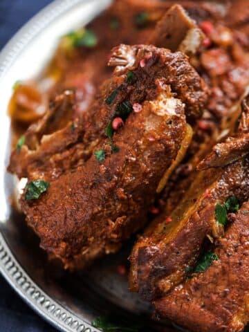 slow cooker country style ribs sprinkled with parsley close up.