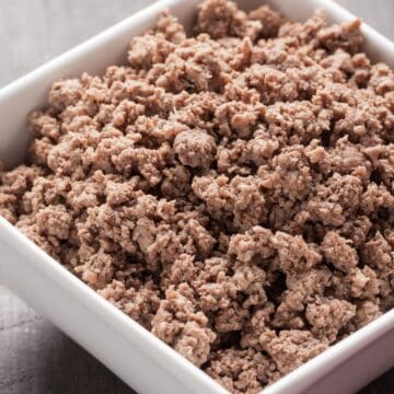 square white bowl full with crumbled browned ground beef.