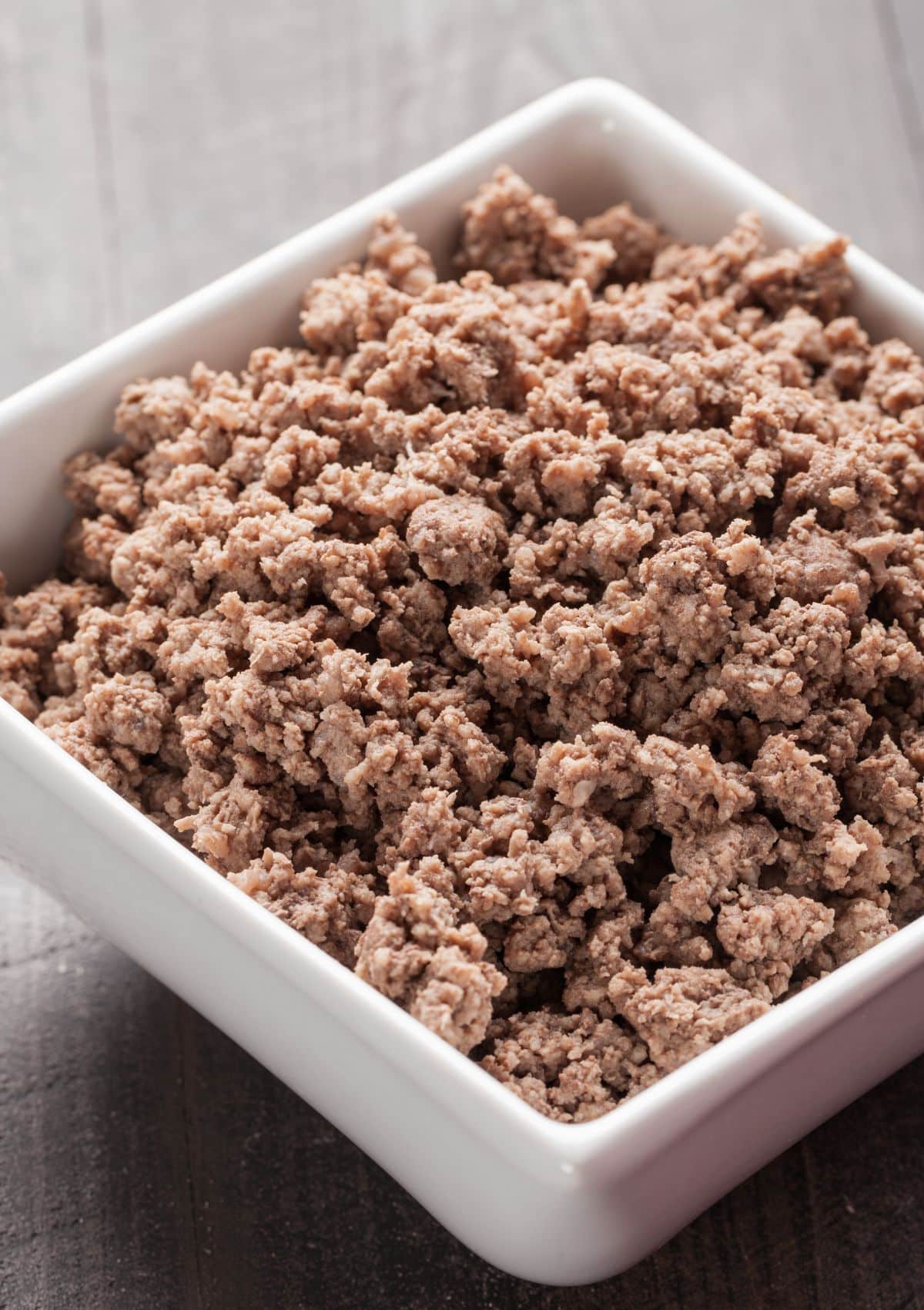 square white bowl full with crumbled browned ground beef.