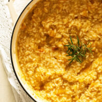 overhead view of half a pot full of pumpkin risotto.