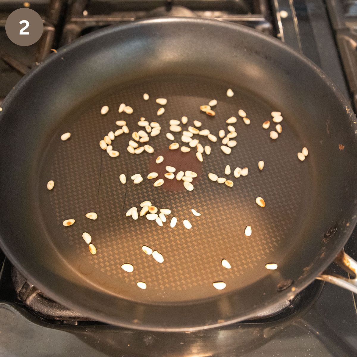 roasting pine nuts in a frying pan.