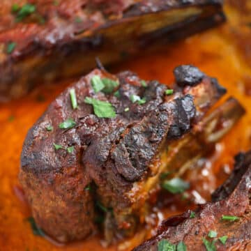 browned pork ribs in pan juices.