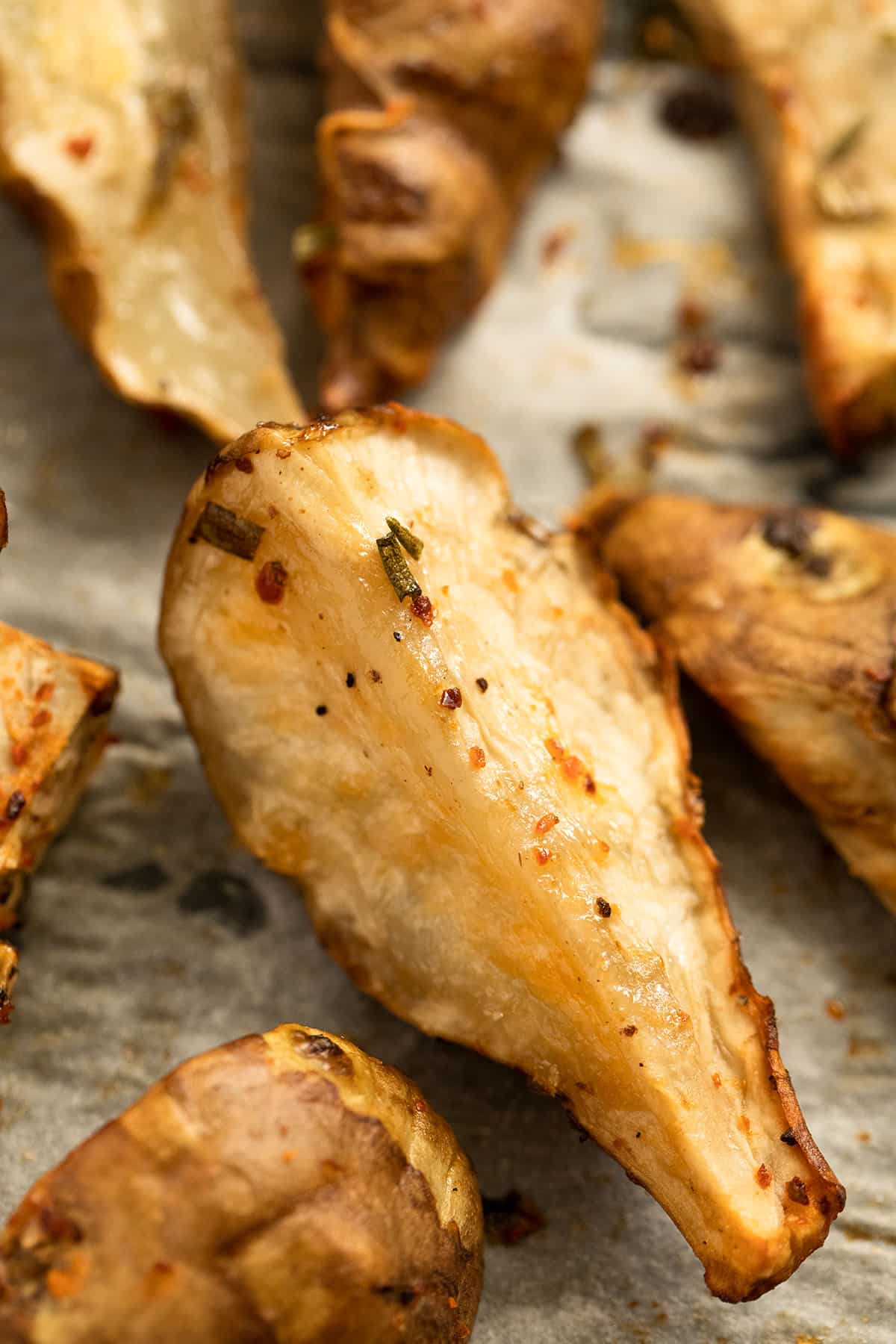 close up of a golden roasted piece of jerusalem artichokes.