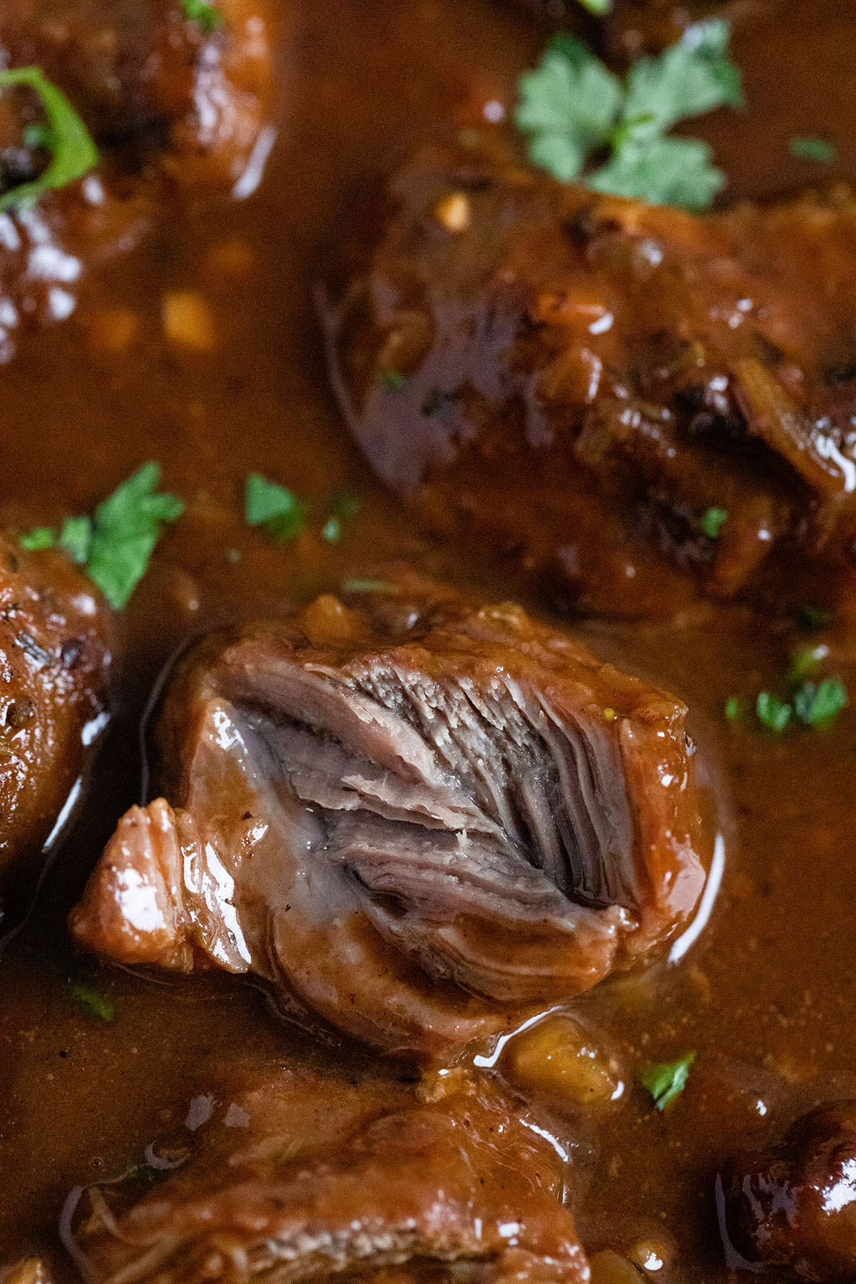 melt in your mouth pork cheeks sourrounded by gravy.