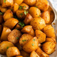 slow cooker roasted potatoes on a vintage platter.