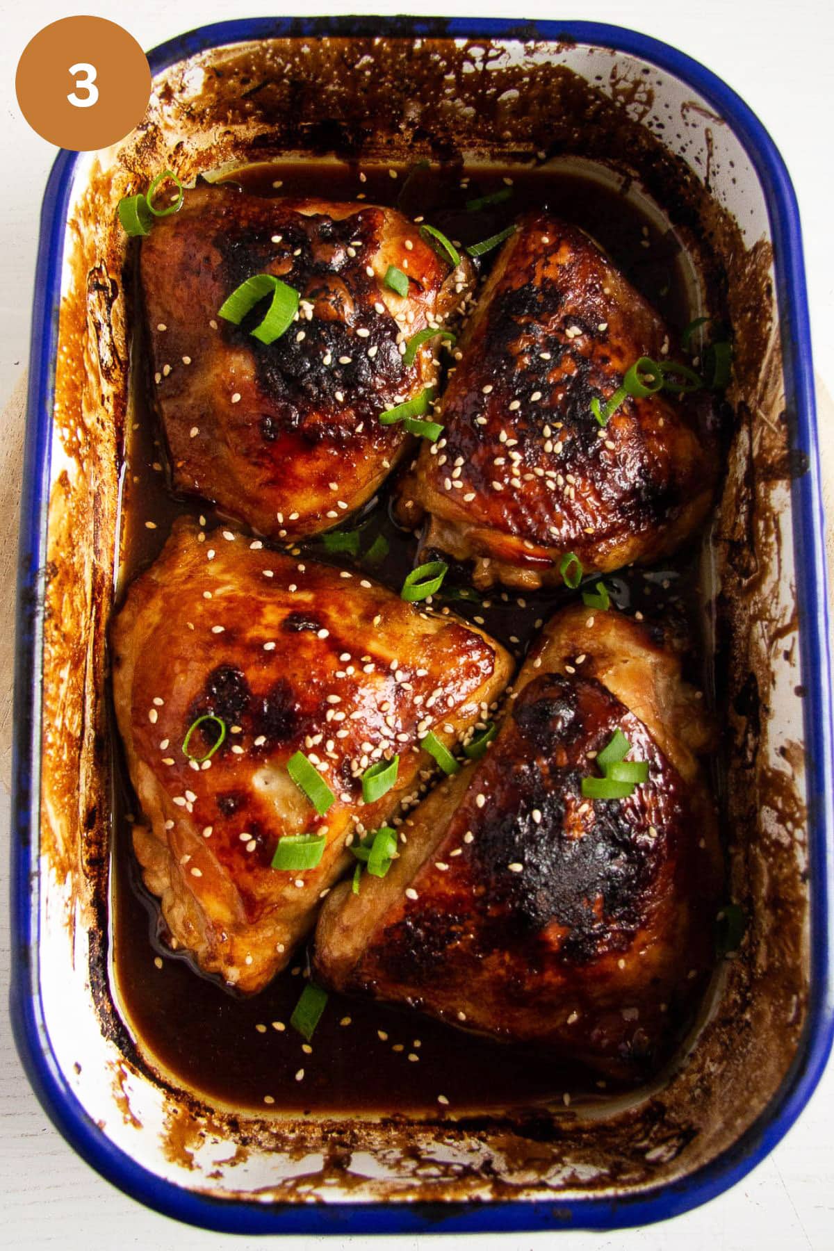 broiled chicken thighs in a baking dish.