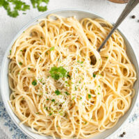 pasta with truffle butter in a bowl and a pot of salt.