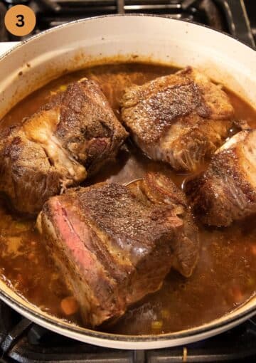 cooking short ribs in a large dutch oven with beer.