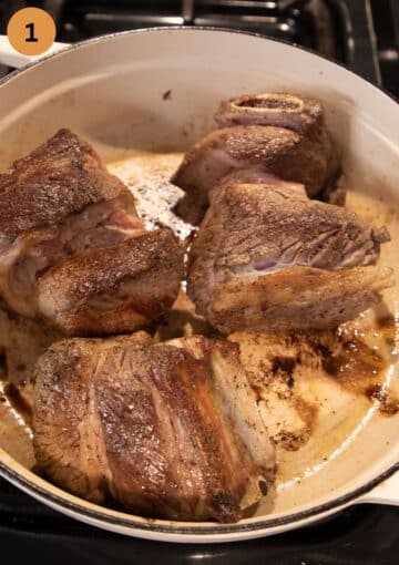 browning short ribs in a large dutch oven.