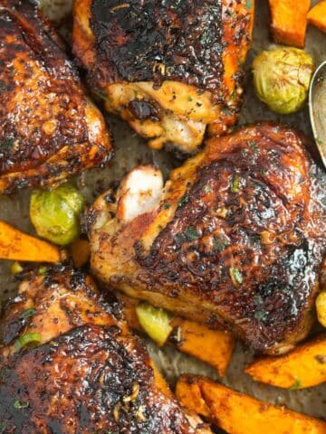 four baked chicken and sweet potatoes close up.