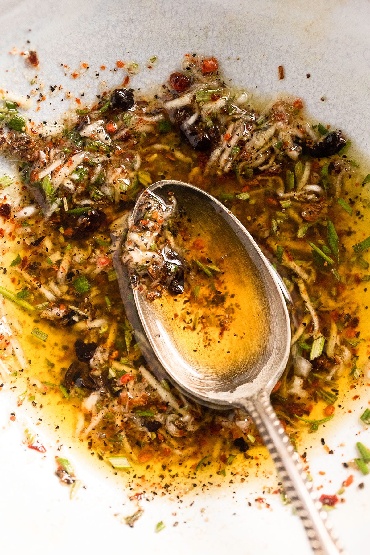 close up marinade for lamb with olive oil, garlic and rosemary.