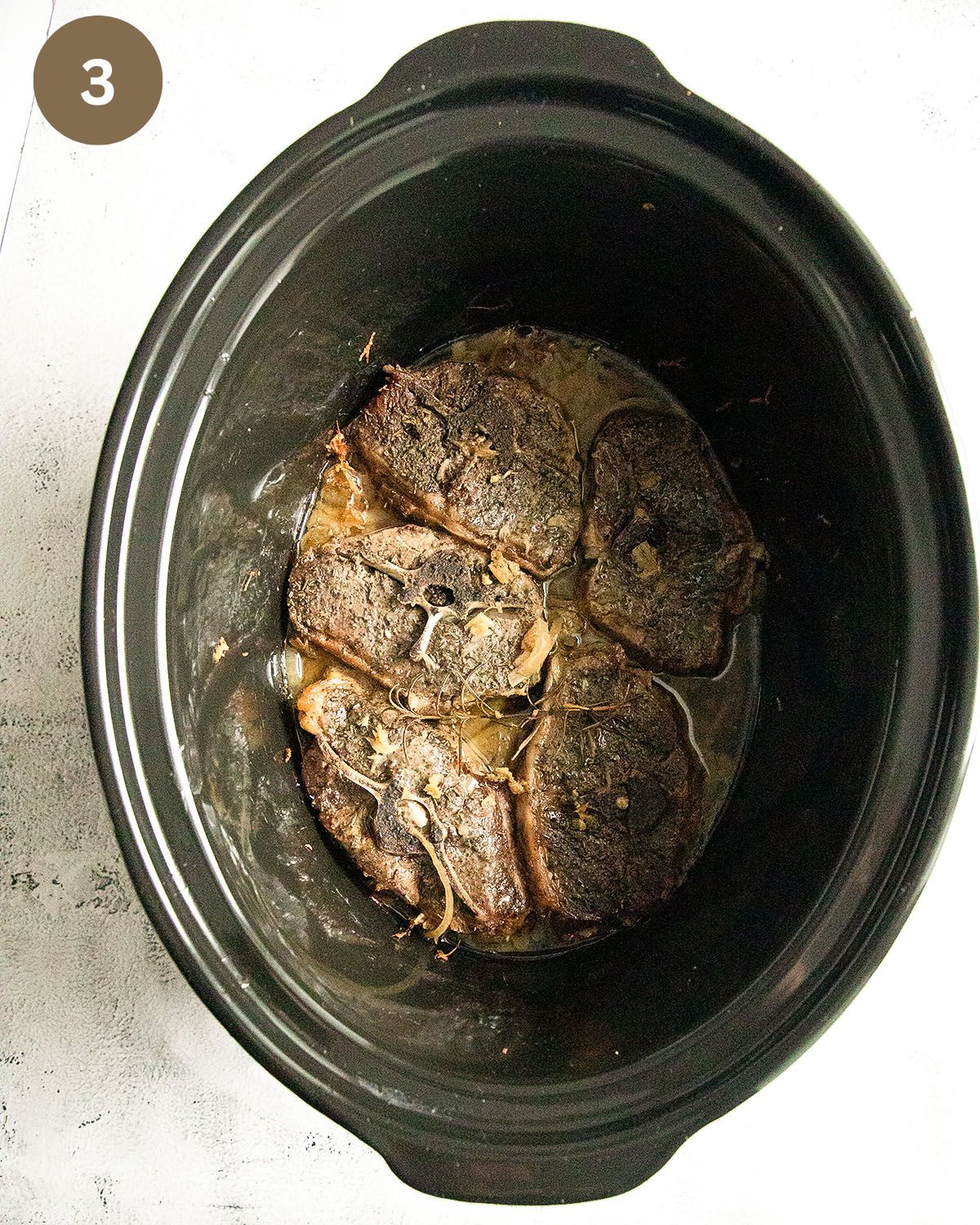 lamb chops in the pot of a slow cooker or crockpot.
