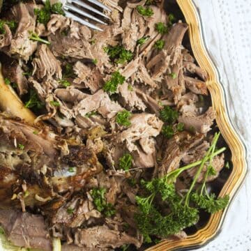 close up slow cooker pulled lamb with parsley.