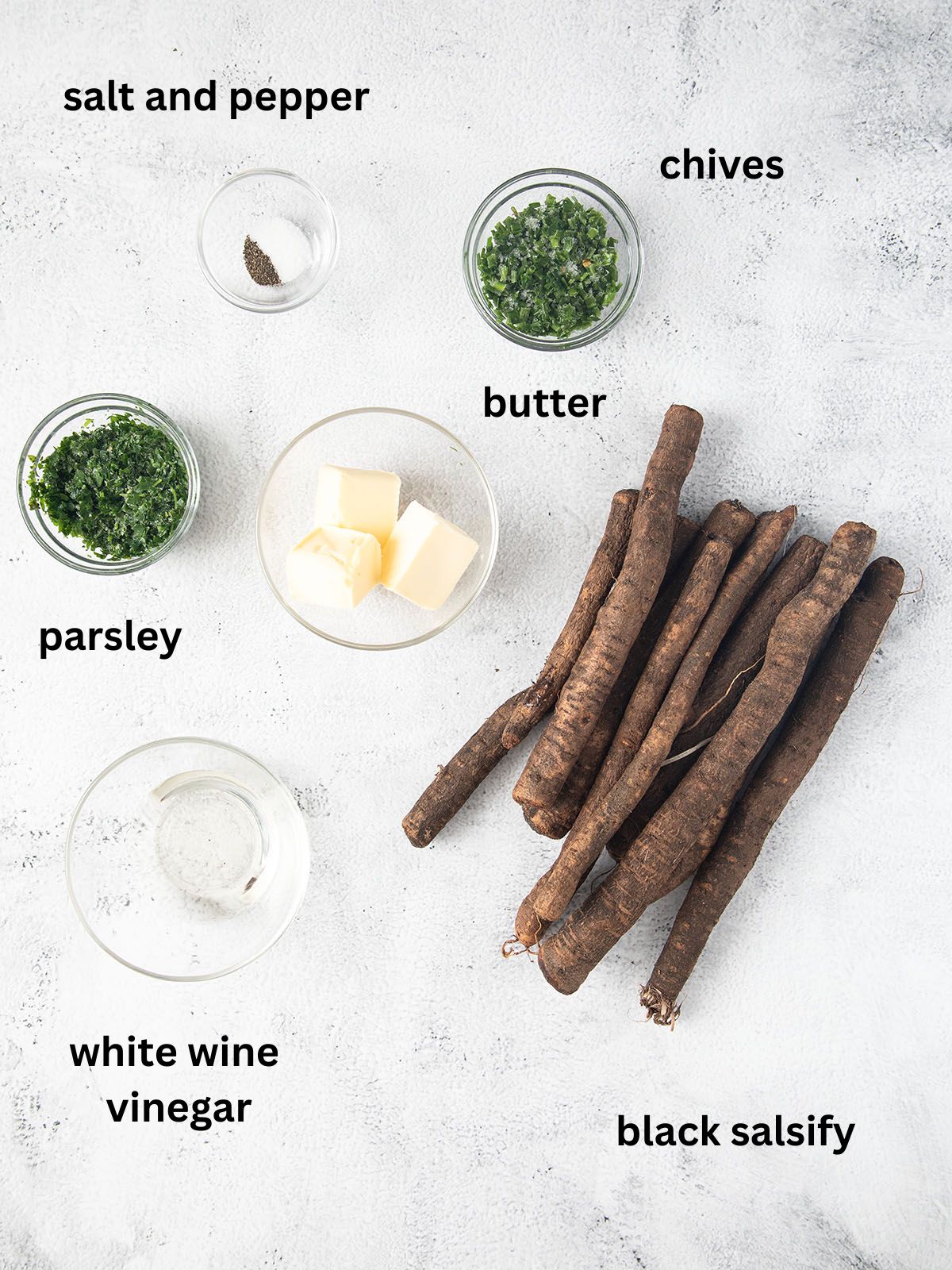 listed ingredients for cooking black salsify in a pan.