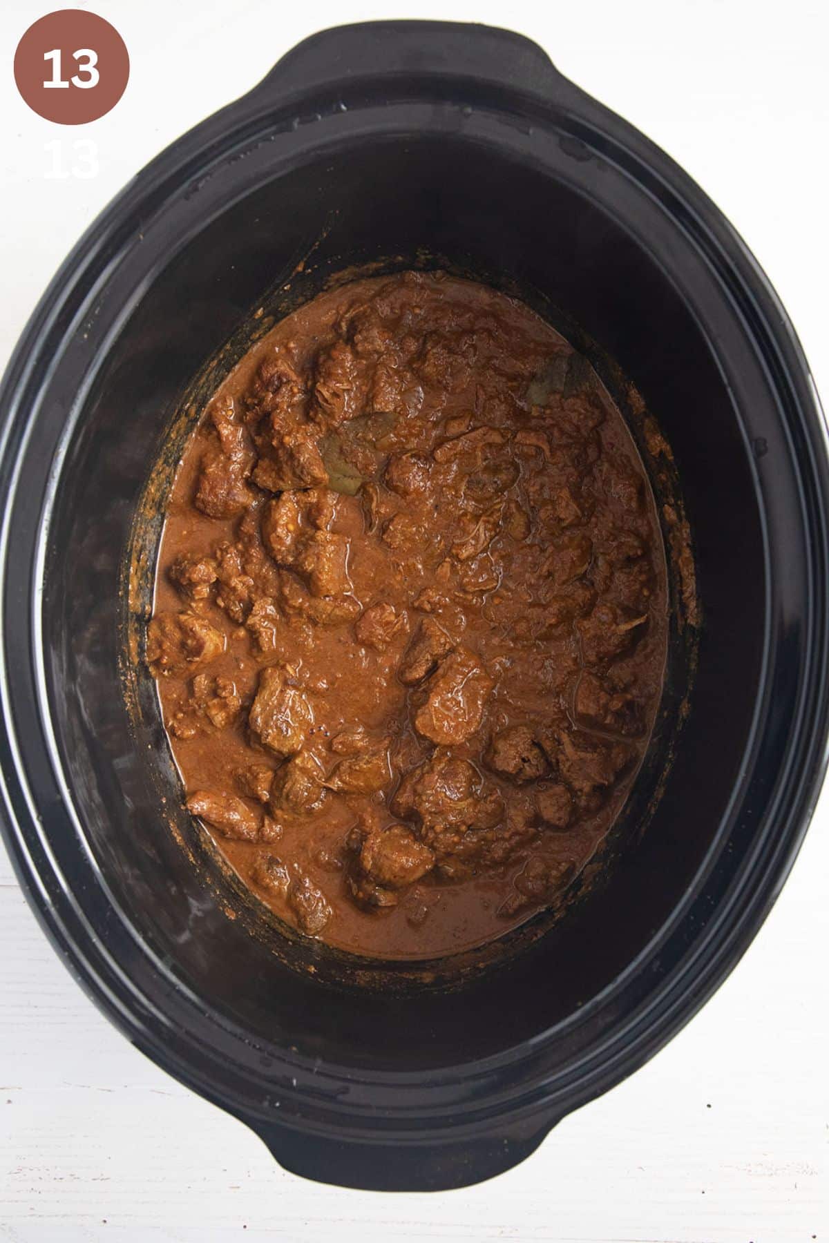 lamb curry in the pot of the slow cooker.