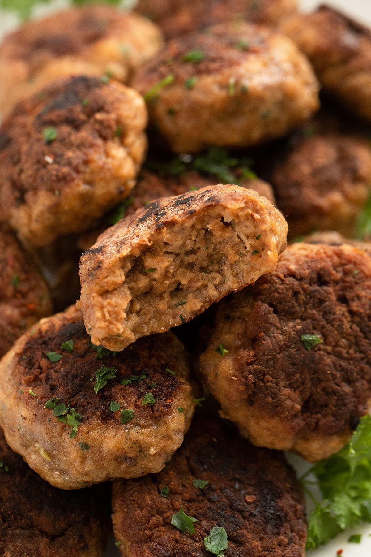 close up meatballs with ground veal, one split in the middle.