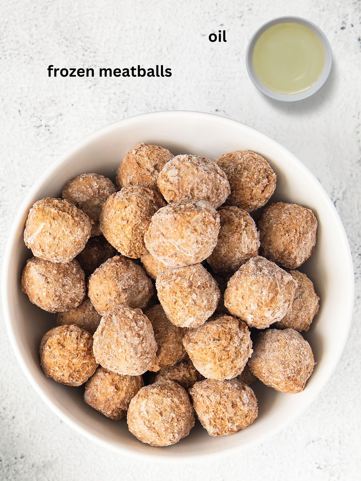 frozen meatballs and a small bowl with cooking oil.