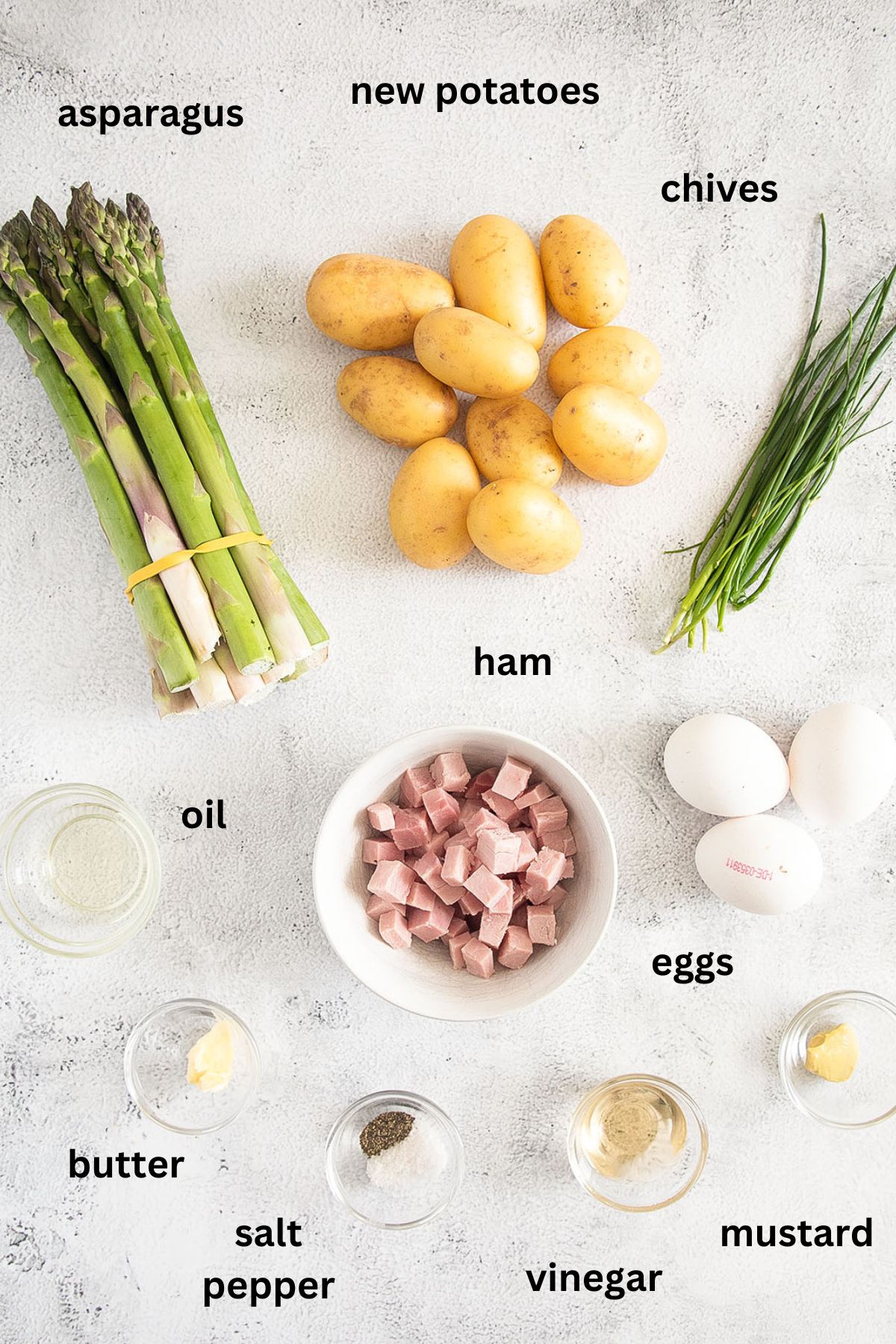 listed ingredients for making asparagus salad with potatoes, ham, eggs and chives.