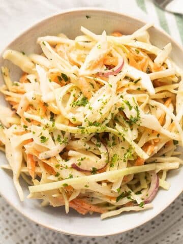 coleslaw for burgers in a small white bowl.