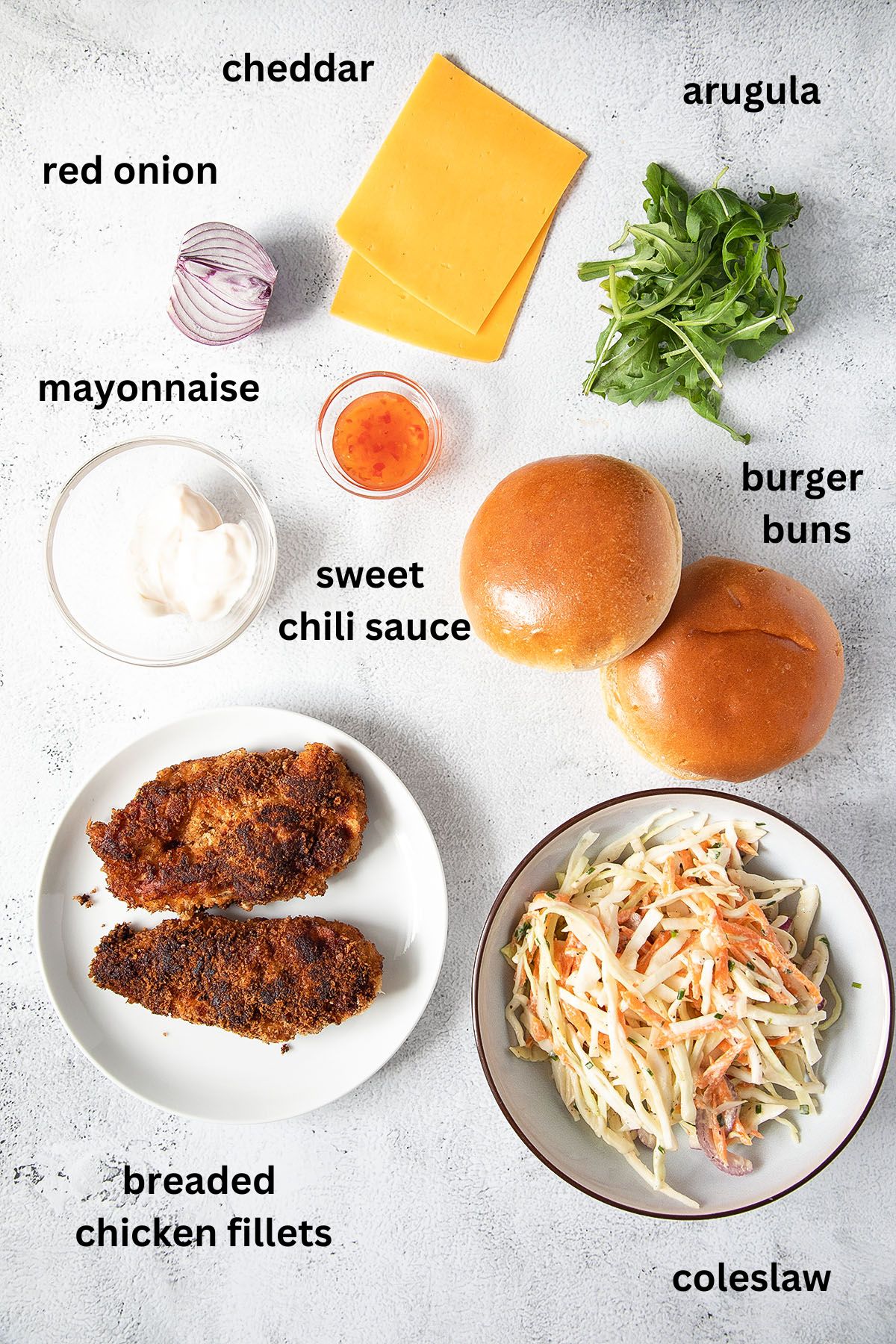 listed ingredients for making burgers with chicken fillet, cheddar and coleslaw.