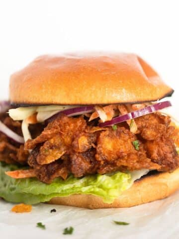 crispy chicken burger with coleslaw, lettuce and red onions.