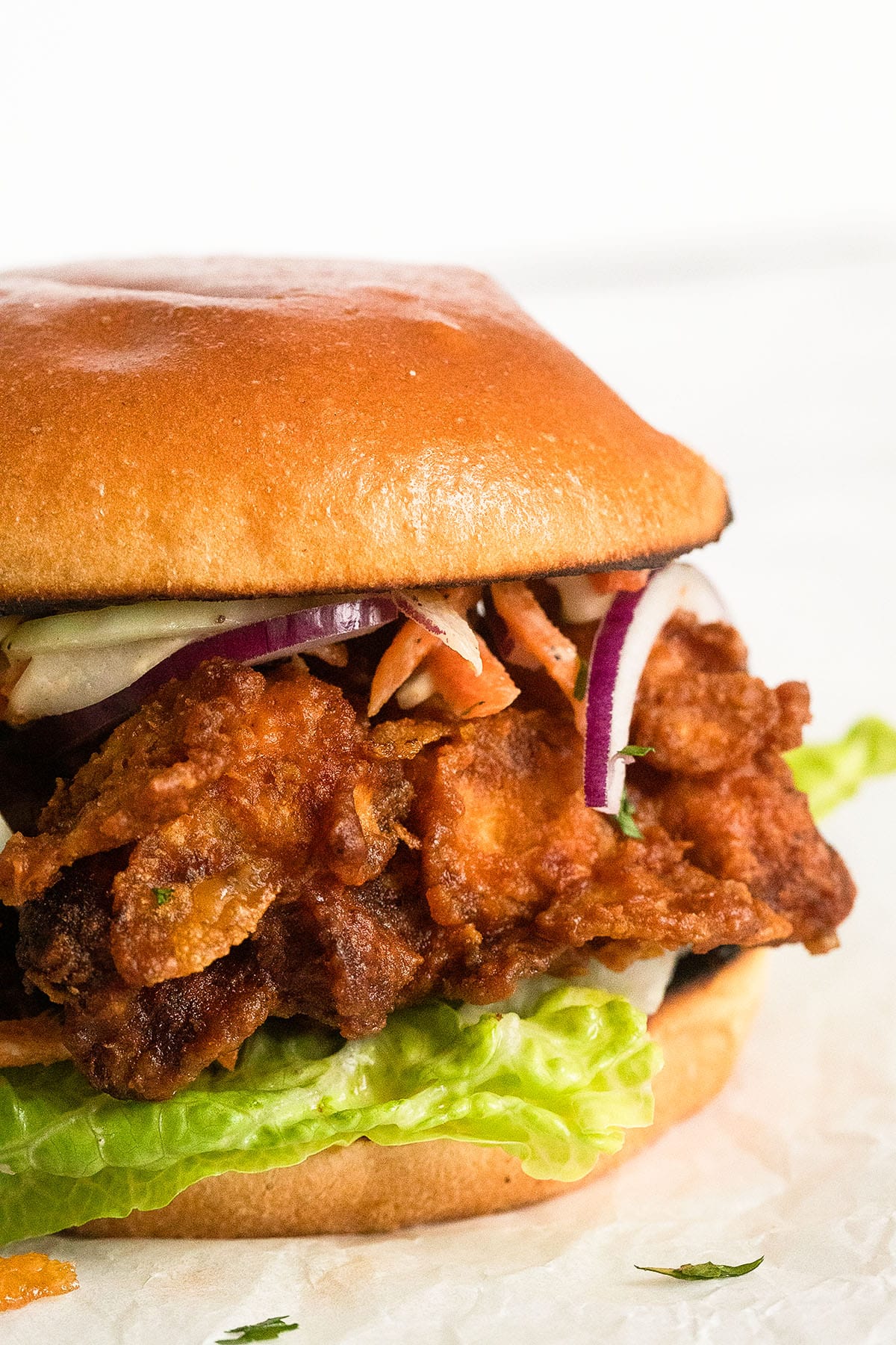 crunchy fried chicken burger with lettuce close up.