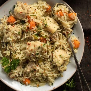 slow cooker chicken and rice served on a small white plate.