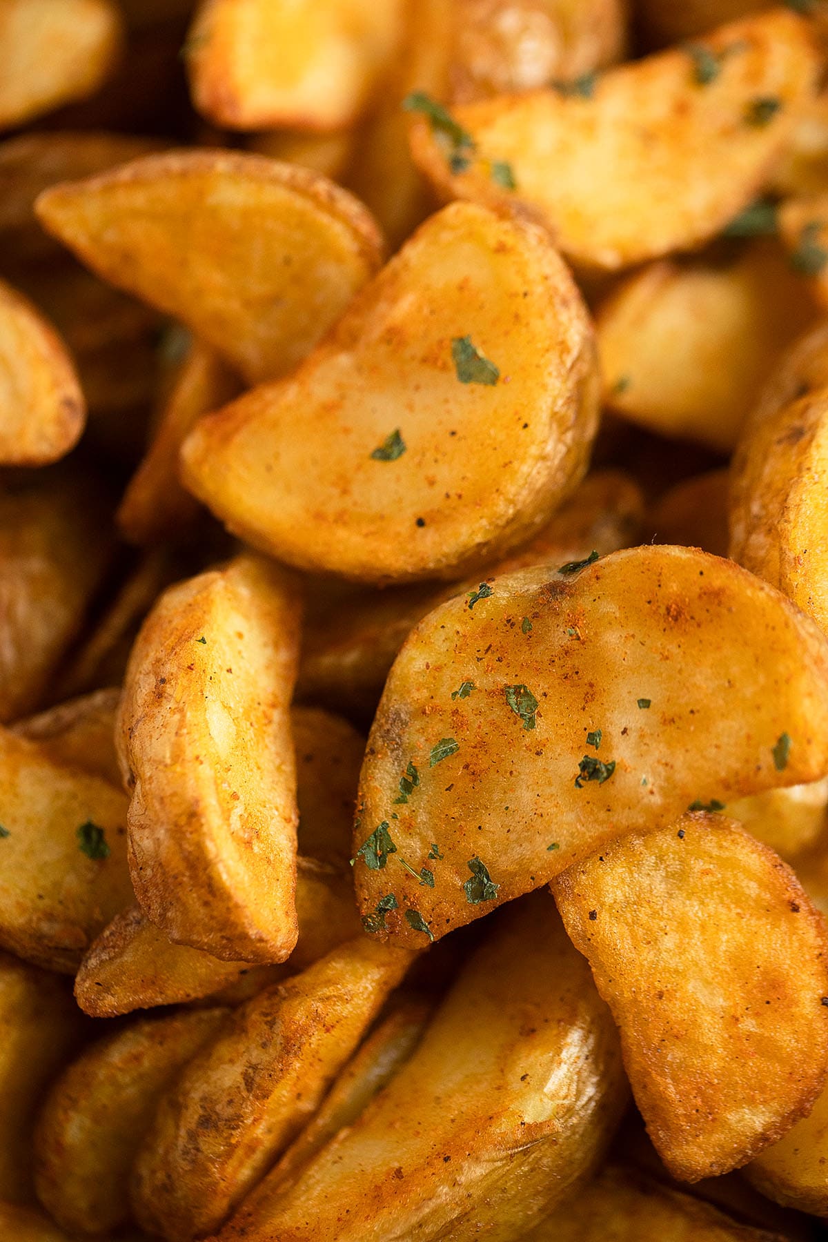 close up of crispy and golden air fryer frozen potato wedges.