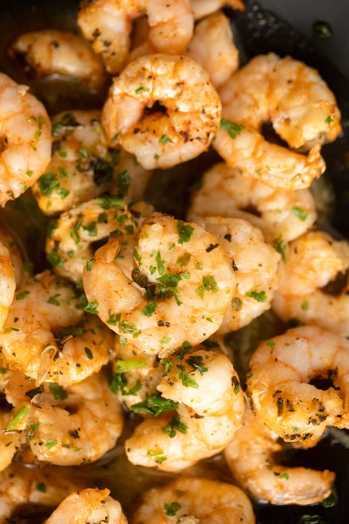 close up of air fried shrimp with parsley on top.