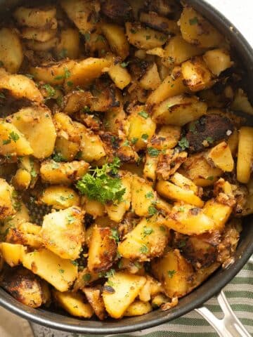 fried potatoes and onions in a skillet.