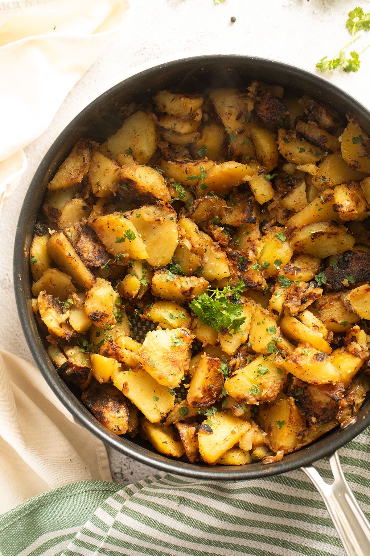 golden brown potatoes cooked with onions in a skillet.