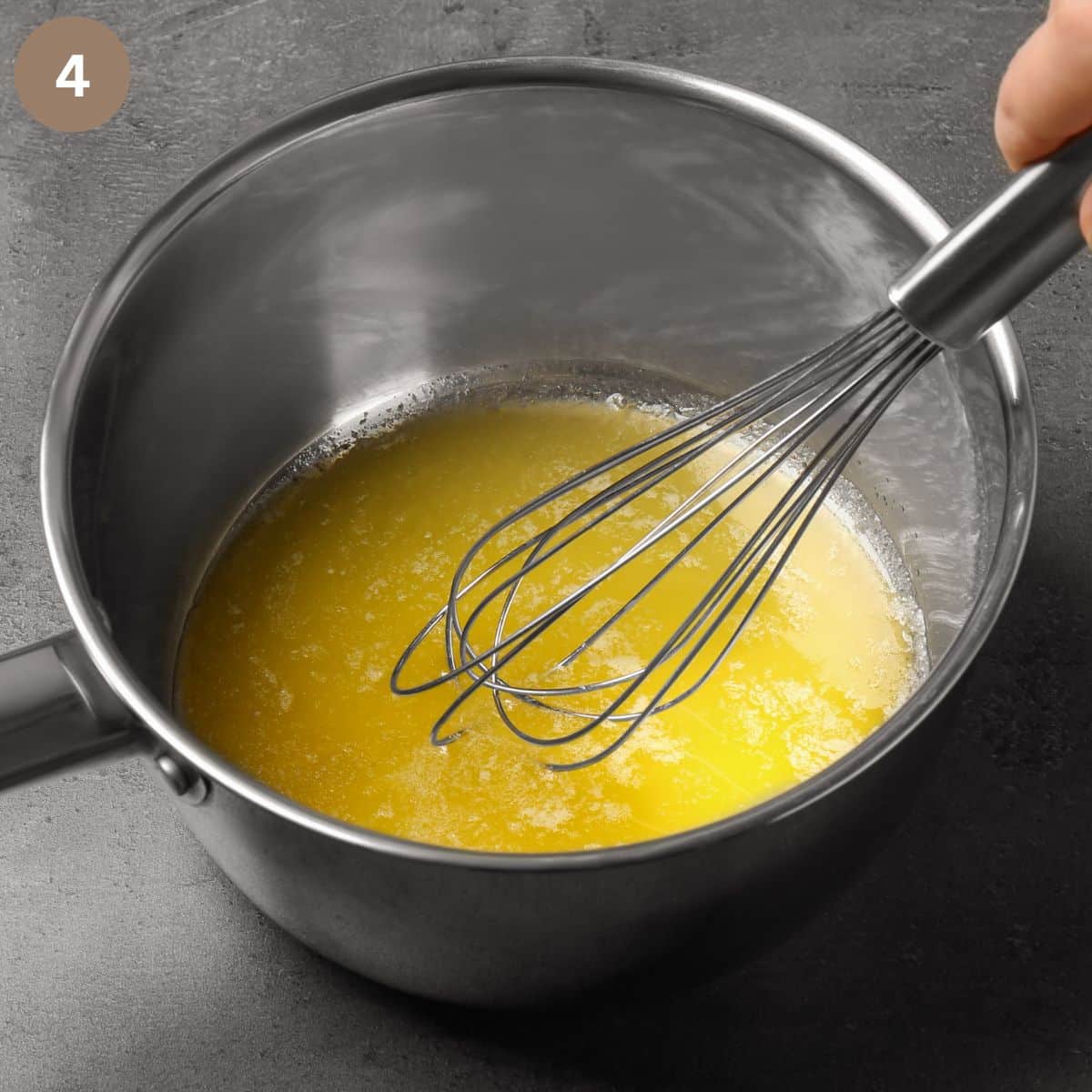 melting butter in a pot and stirring it with a whisk.