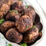 close up of many round and brown pork meatballs.