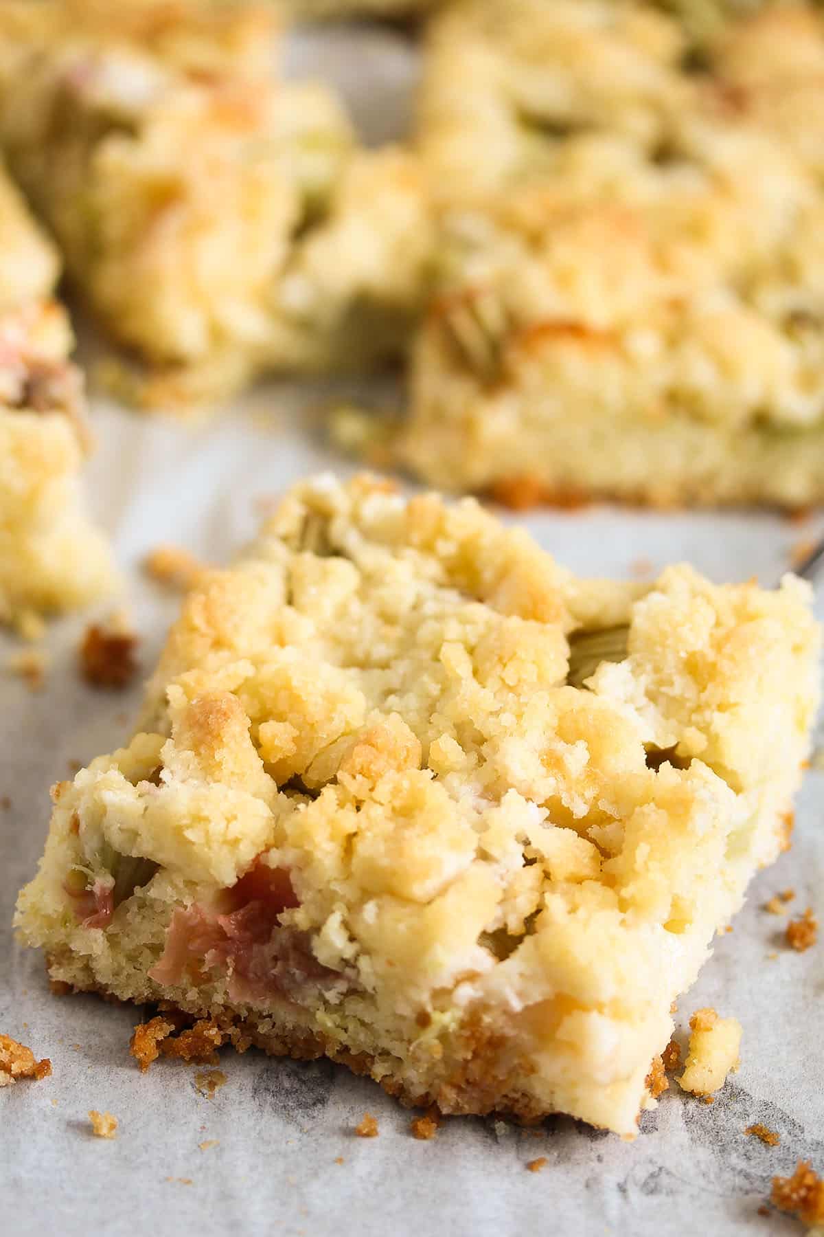 slice of rhubarb crumble cake close up.