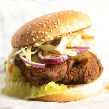 chicken schnitzel burger with lettuce and coleslaw.