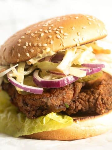 chicken schnitzel burger with lettuce and coleslaw.