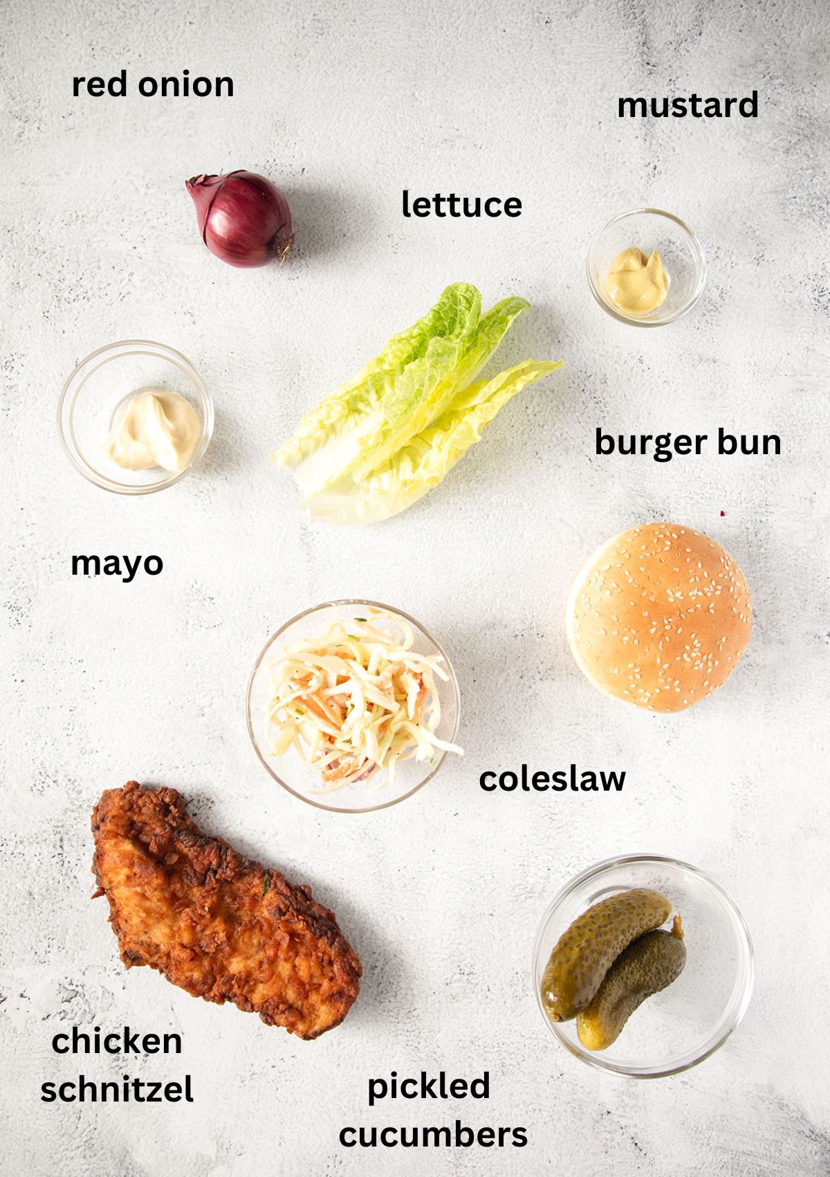 listed ingredients for making burger with chicken schnitzel, lettuce and coleslaw.