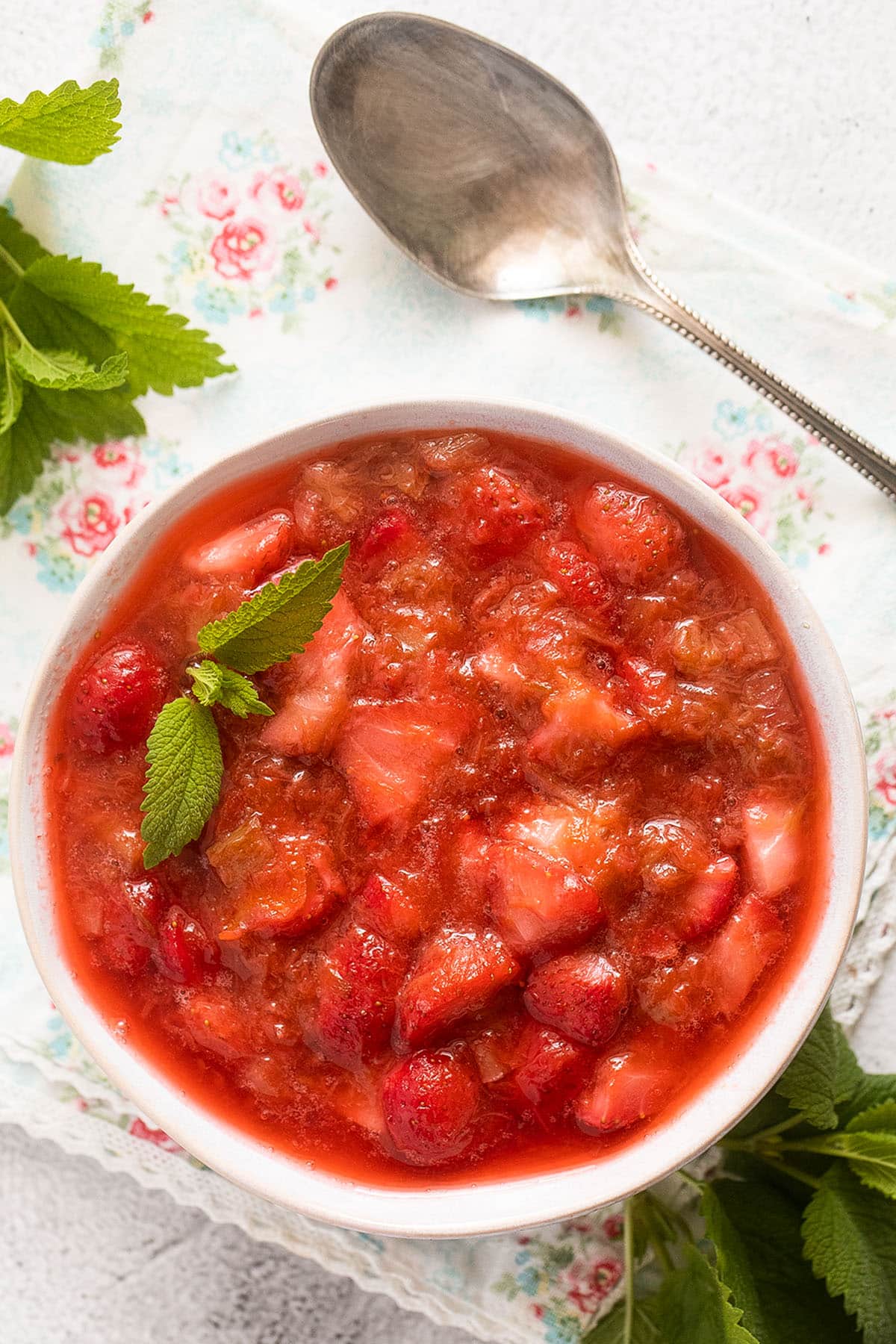 overhead view of a bowl of stewed rhubarb and strawberries.
