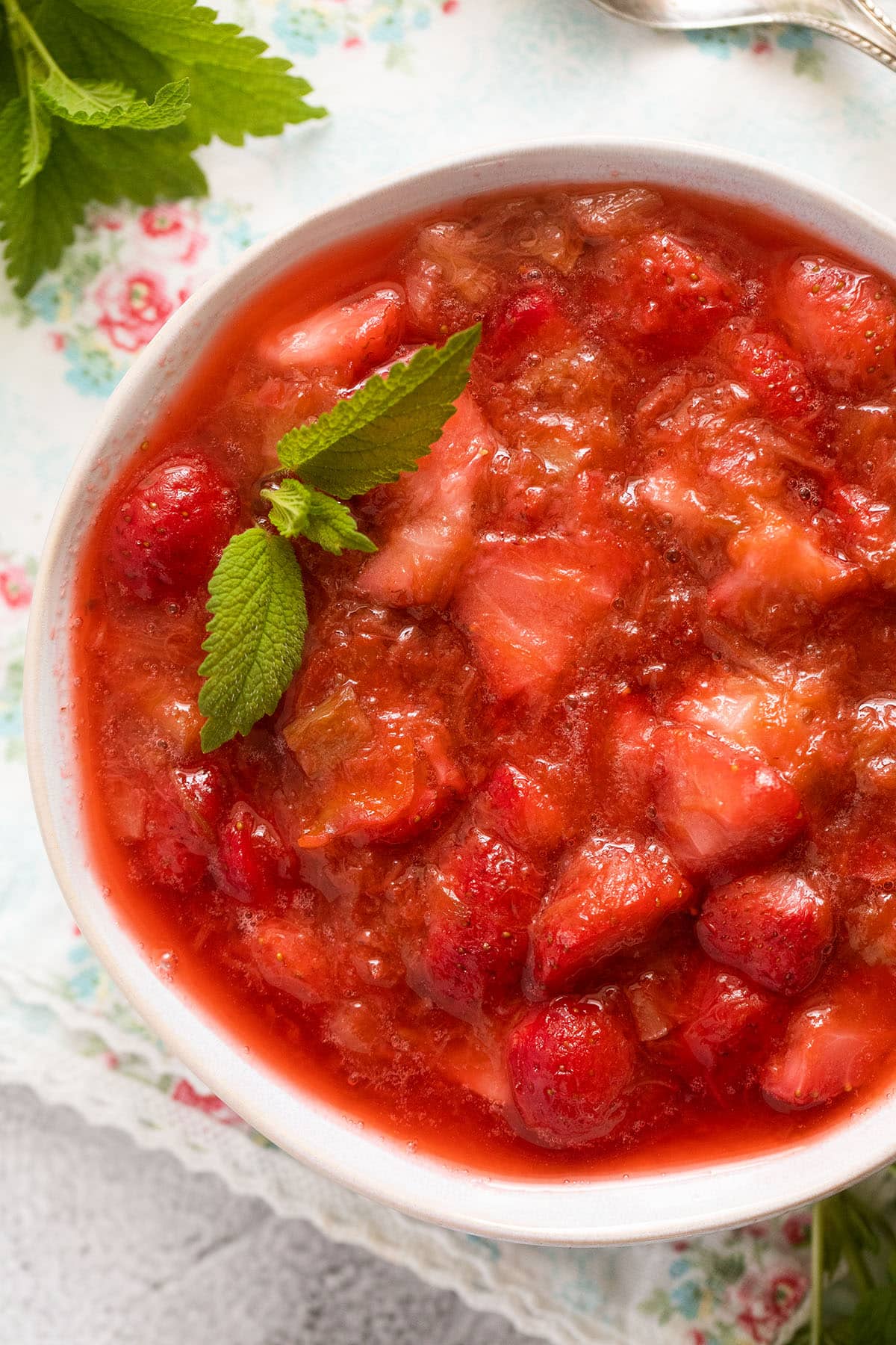 close up sauce with strawberries and rhubarb in a bowl.
