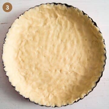 unbaked tart shell in the baking pan.