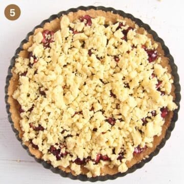 adding crumbles to an unbaked rhubarb tart.