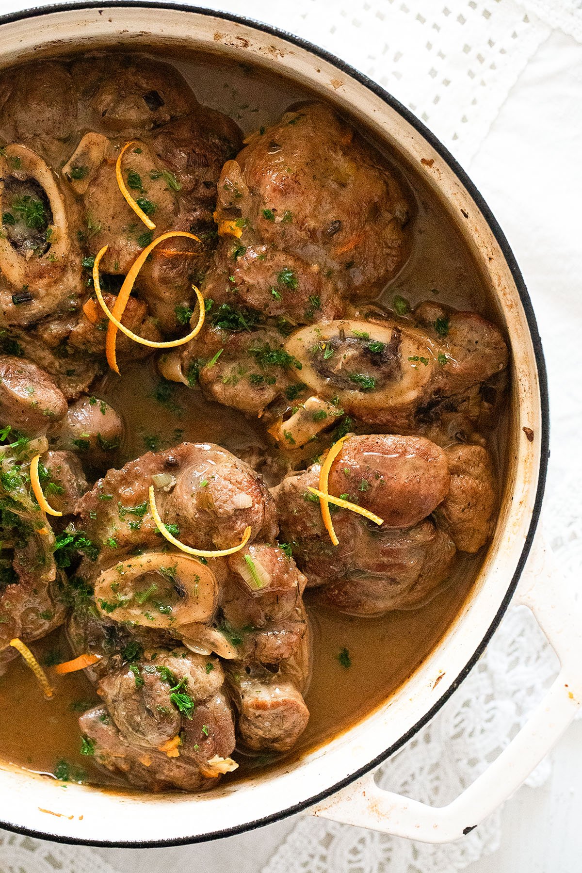 veal shanks with orange sauce in a dutch oven.