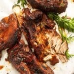 two instant pot country style ribs, one pulled to show the melty flesh.
