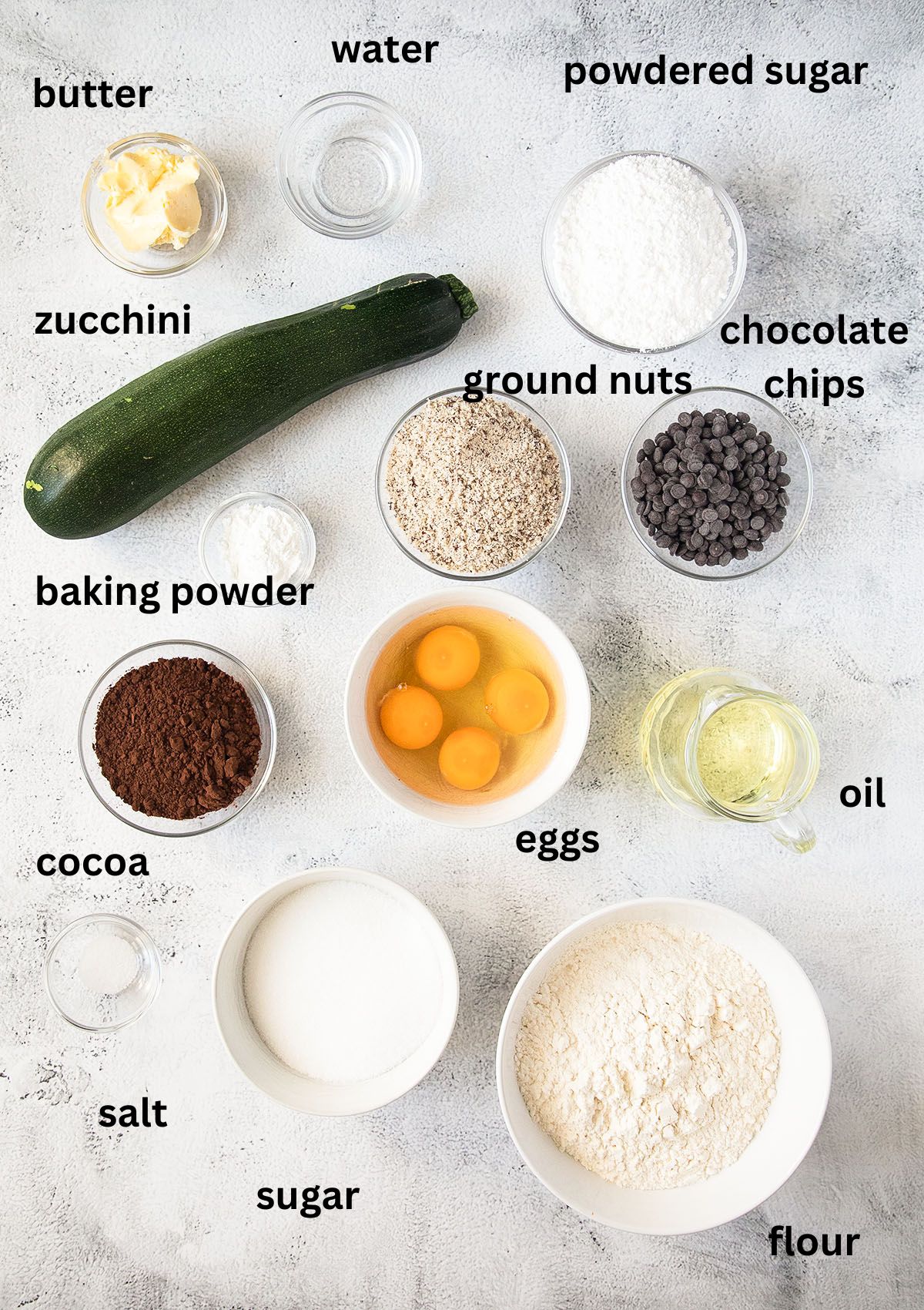 listed ingredients for bundt cake with zucchini, chocolate and ground nuts.