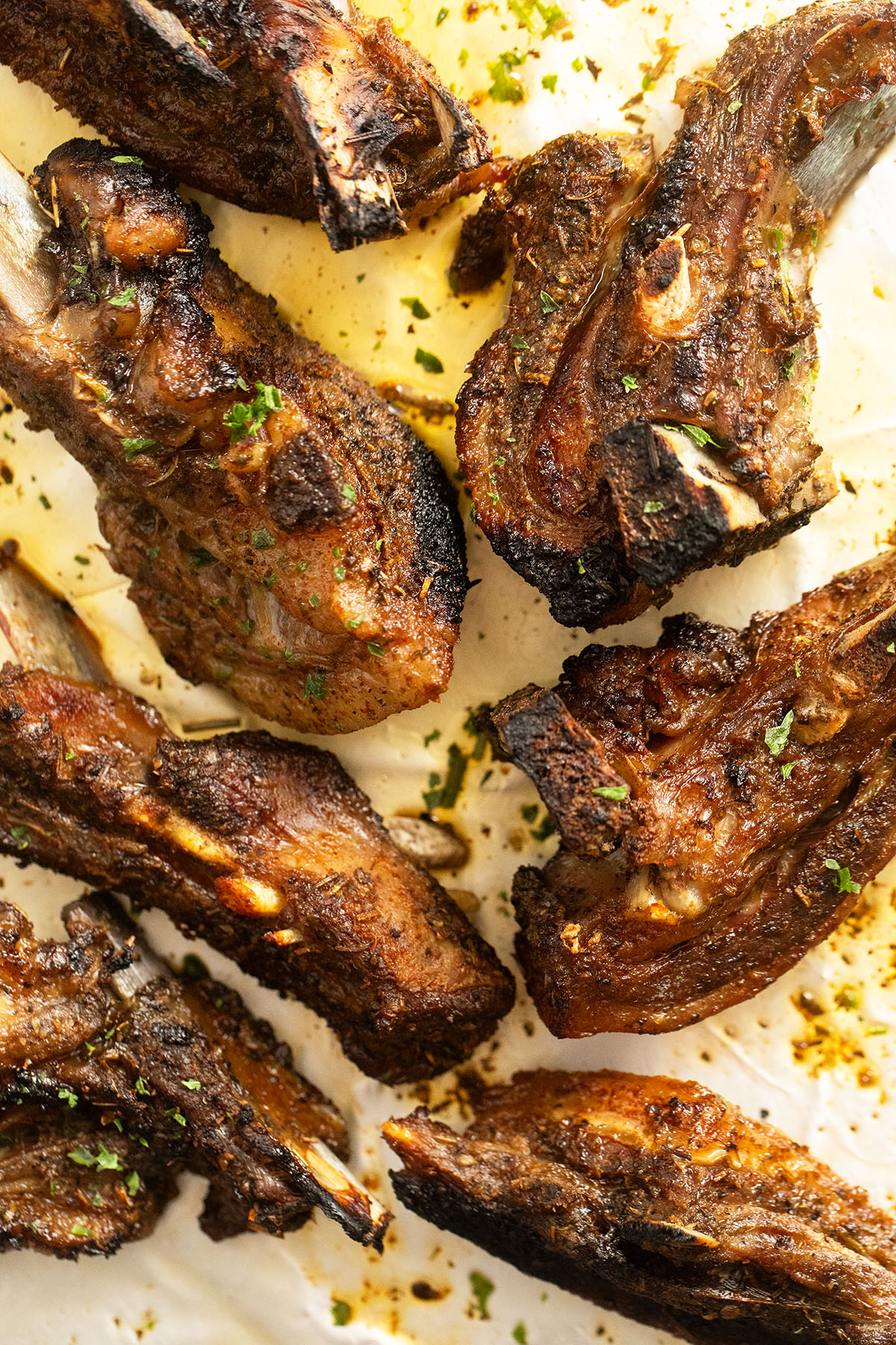 golden broiled lamb riblets overhead view.