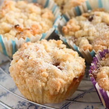 many small nectarine muffins with streusel on top.